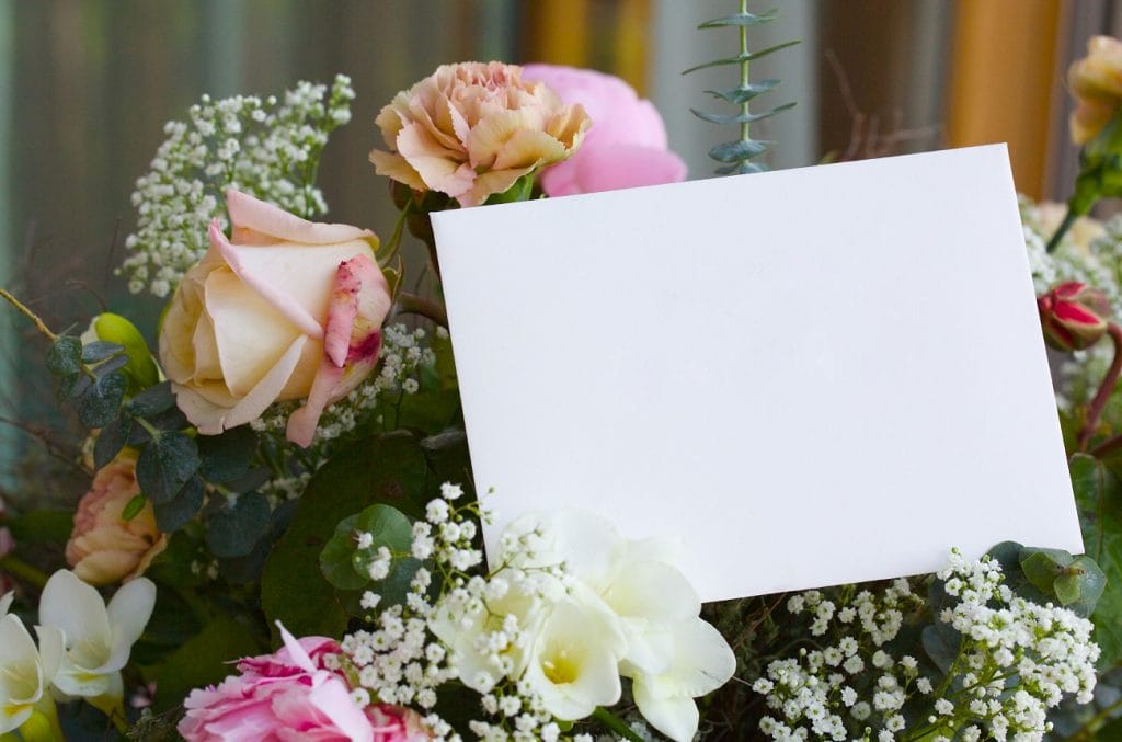 Enveloppe blanche sur bouquet de fleurs